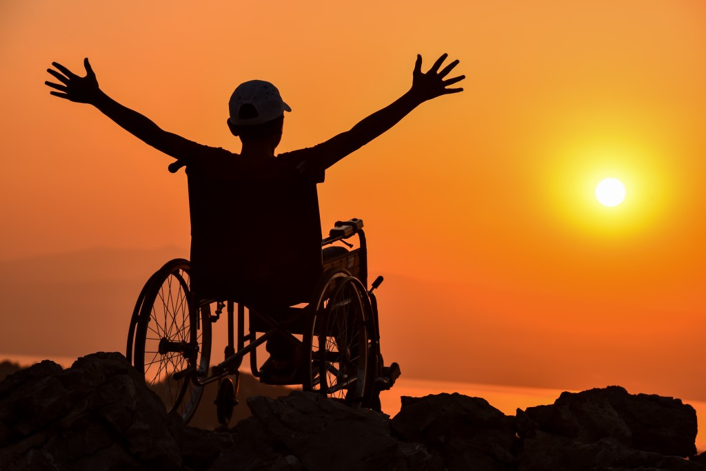 man on a wheelchair watching the sunset