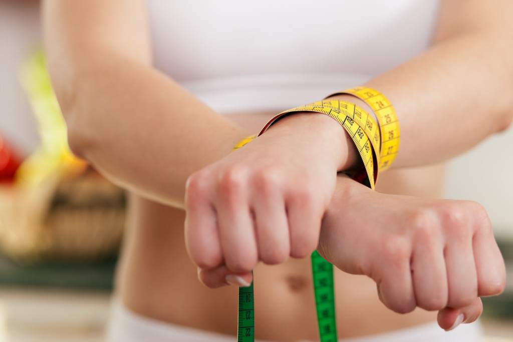 measuring tape on wrist concept of eating disorder