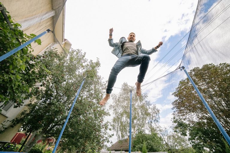 Man jumping high on a trampoline